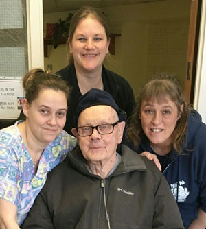 Nursing staff with a resident.
