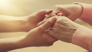 Waterville staff holding residents hands.